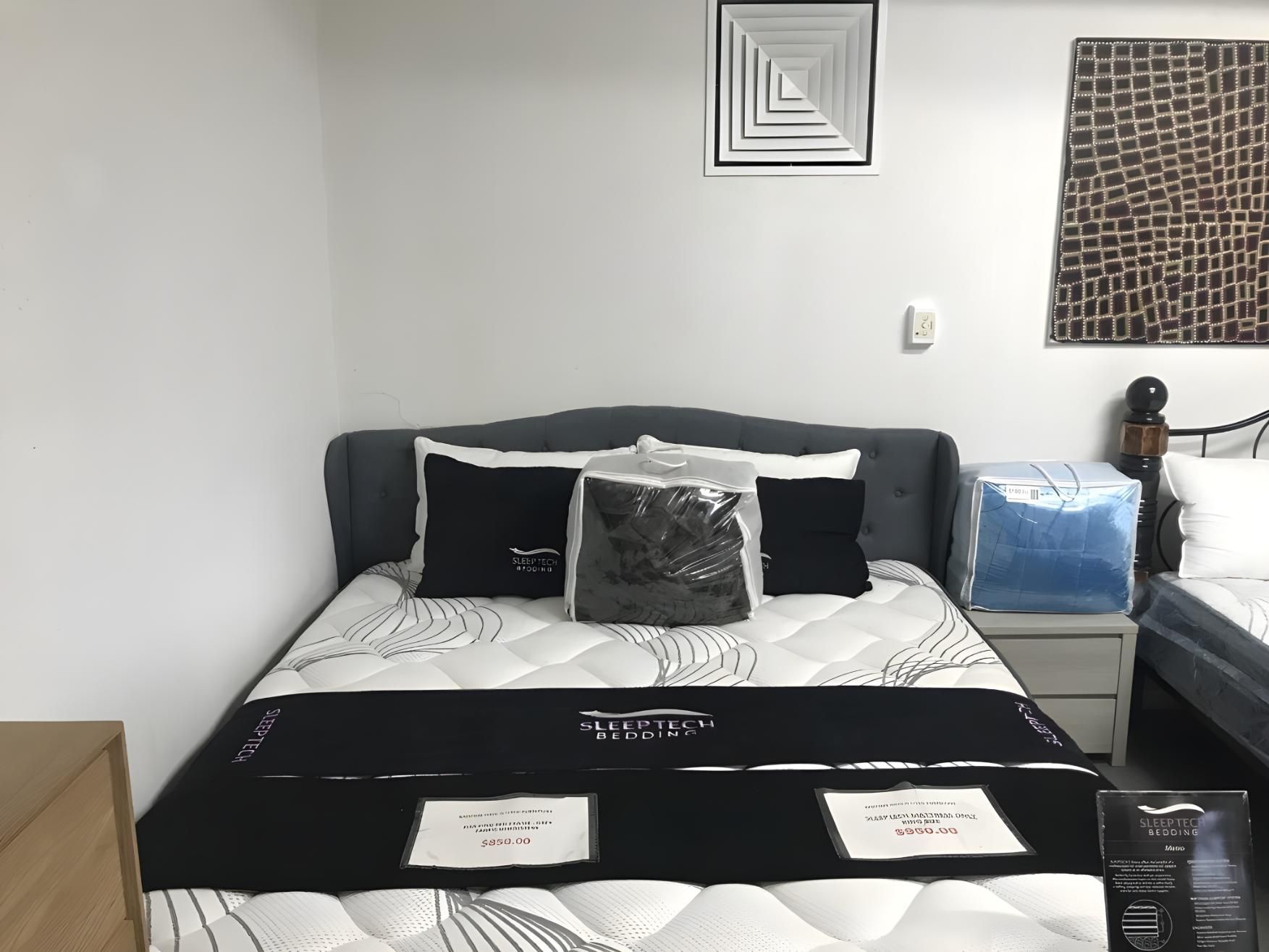 A Bed With A Mattress And Pillows In A Bedroom — Anton's New & Used Furniture In Ciccone, NT