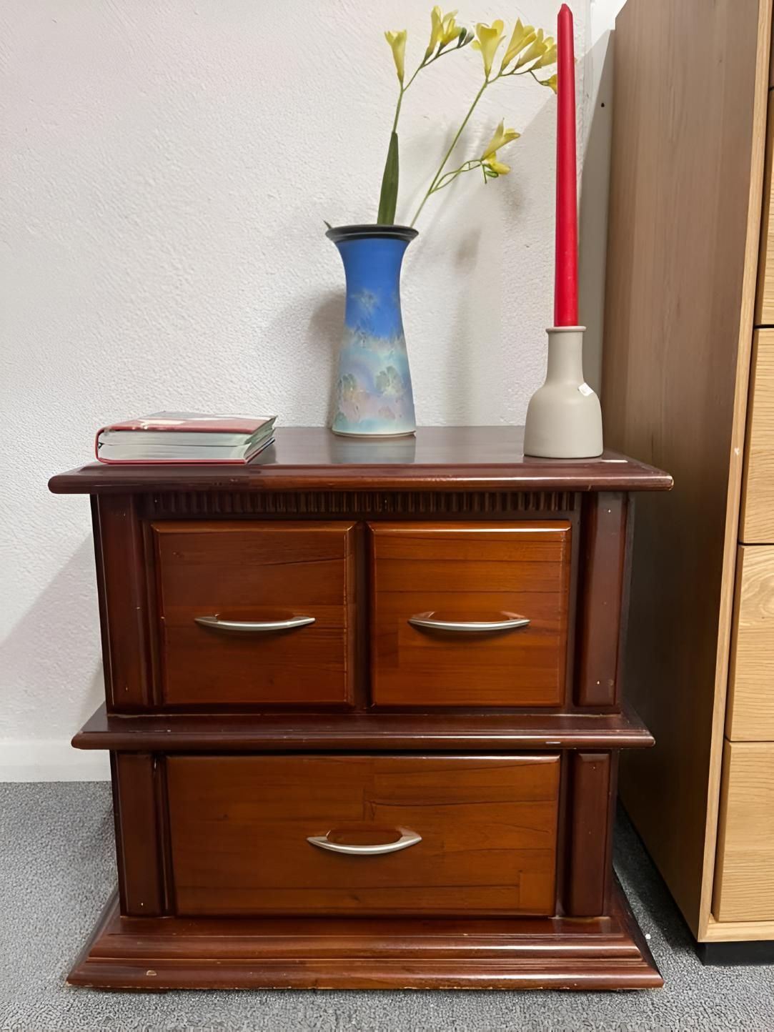 A Wooden Nightstand With Two Drawers And A Vase Of Flowers On — Anton's New & Used Furniture In Ciccone, NT