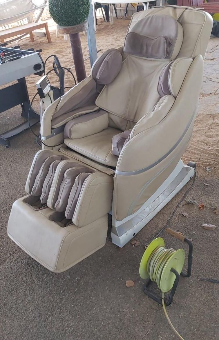 A Massage Chair Is Sitting On The Floor Next To A Hose — Anton's New & Used Furniture In Ciccone, NT