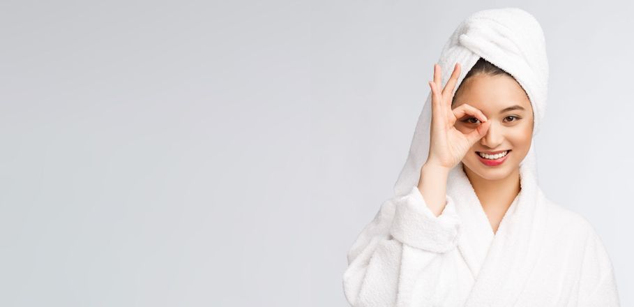 Close-up of a woman applying a rejuvenating serum to her face for a radiant glow