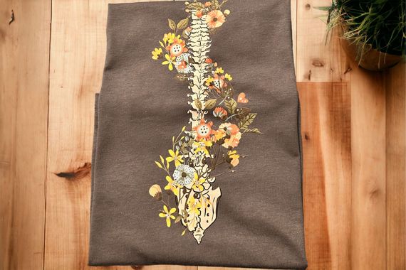 Gray fabric with a floral design featuring a spine and flowers.
