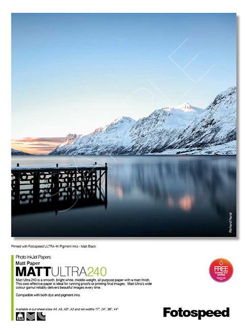 A poster with a picture of a lake and mountains on it.