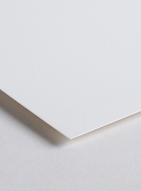 A close up of a piece of white paper on a white surface.
