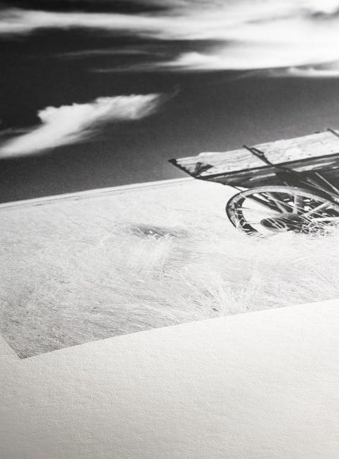 A black and white photo of a horse drawn carriage in the snow.
