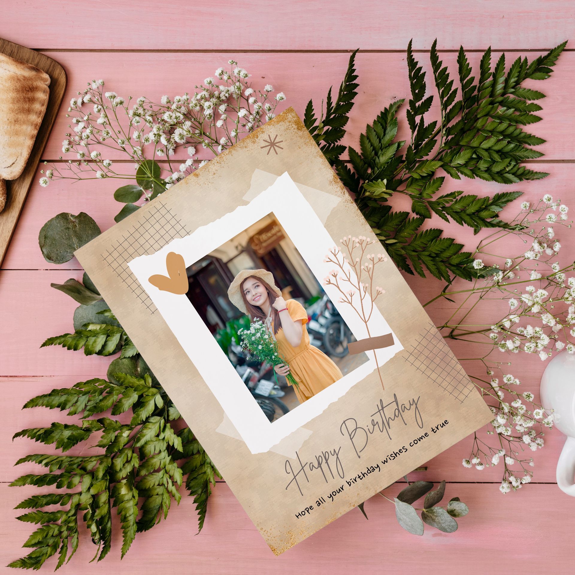 A bunch of cards and envelopes on a table with a plant and pencils