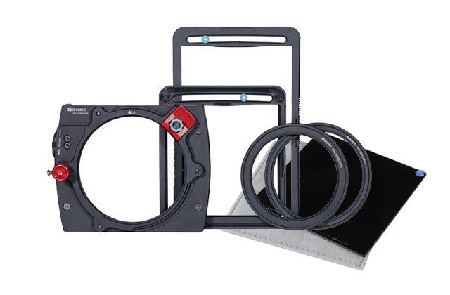 A group of camera filters are sitting on top of each other on a white background.