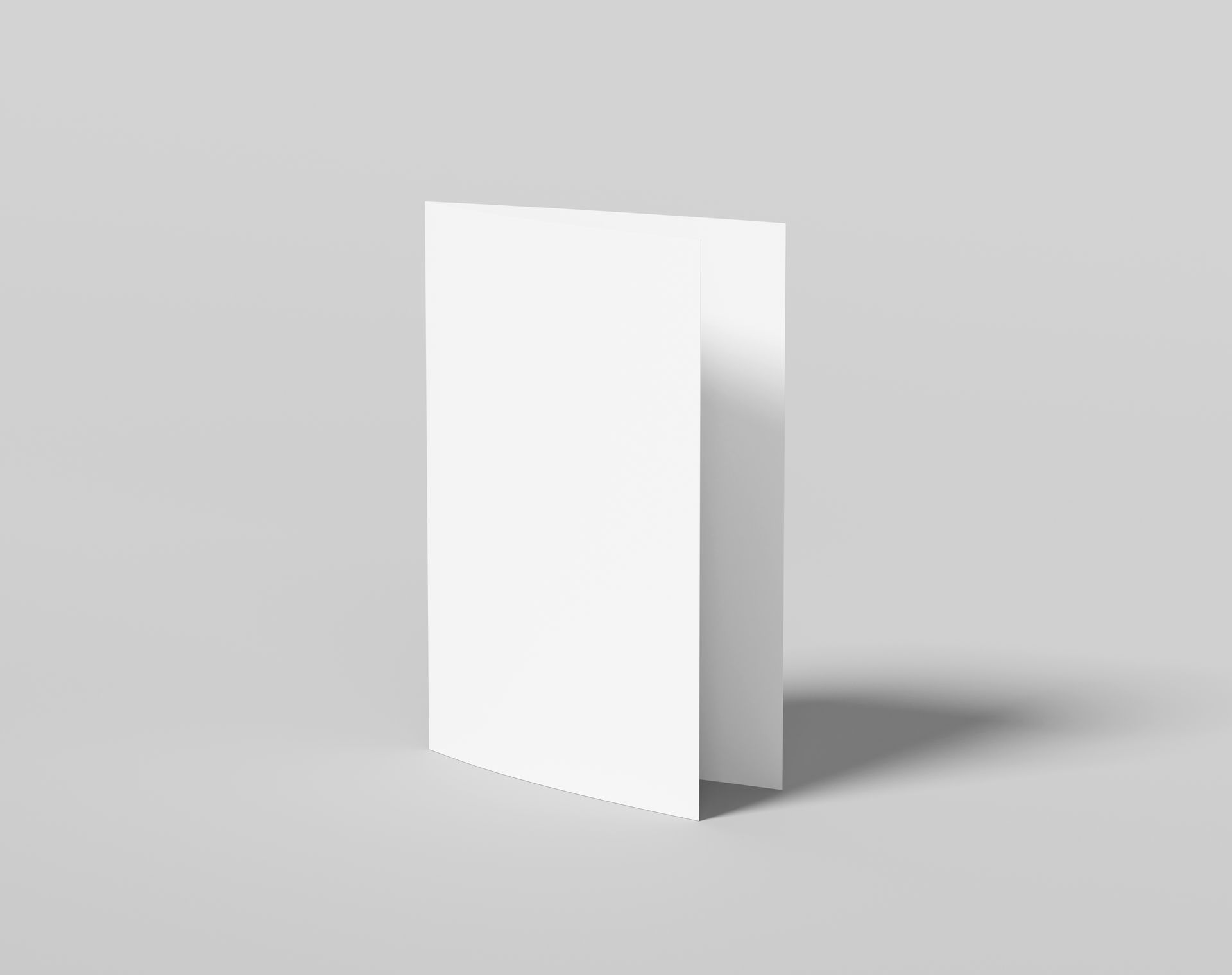 A white greeting card is sitting on a gray surface.