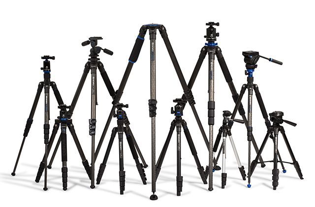 A group of tripods are lined up in a row on a white background