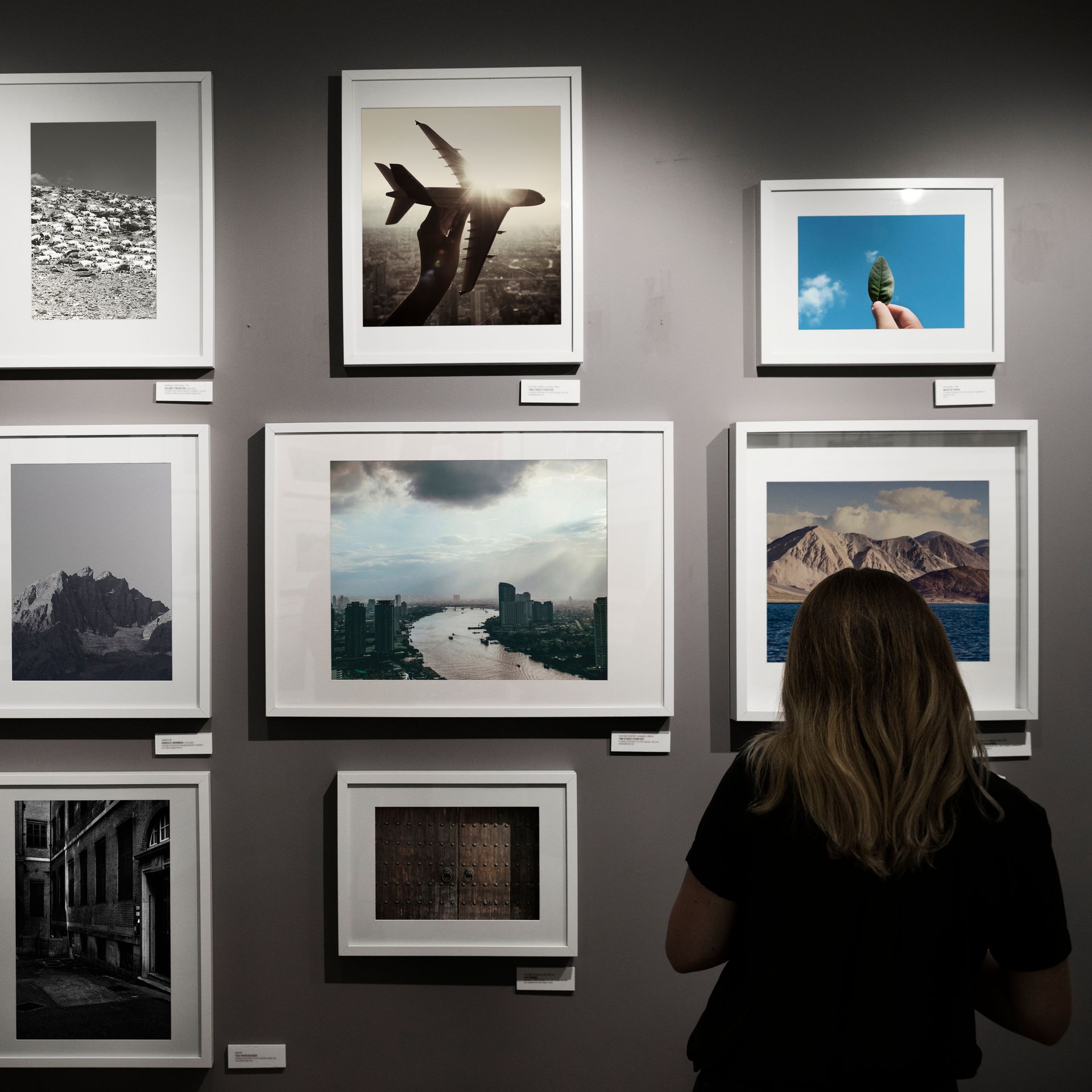A large empty room with paintings on the walls in a museum.