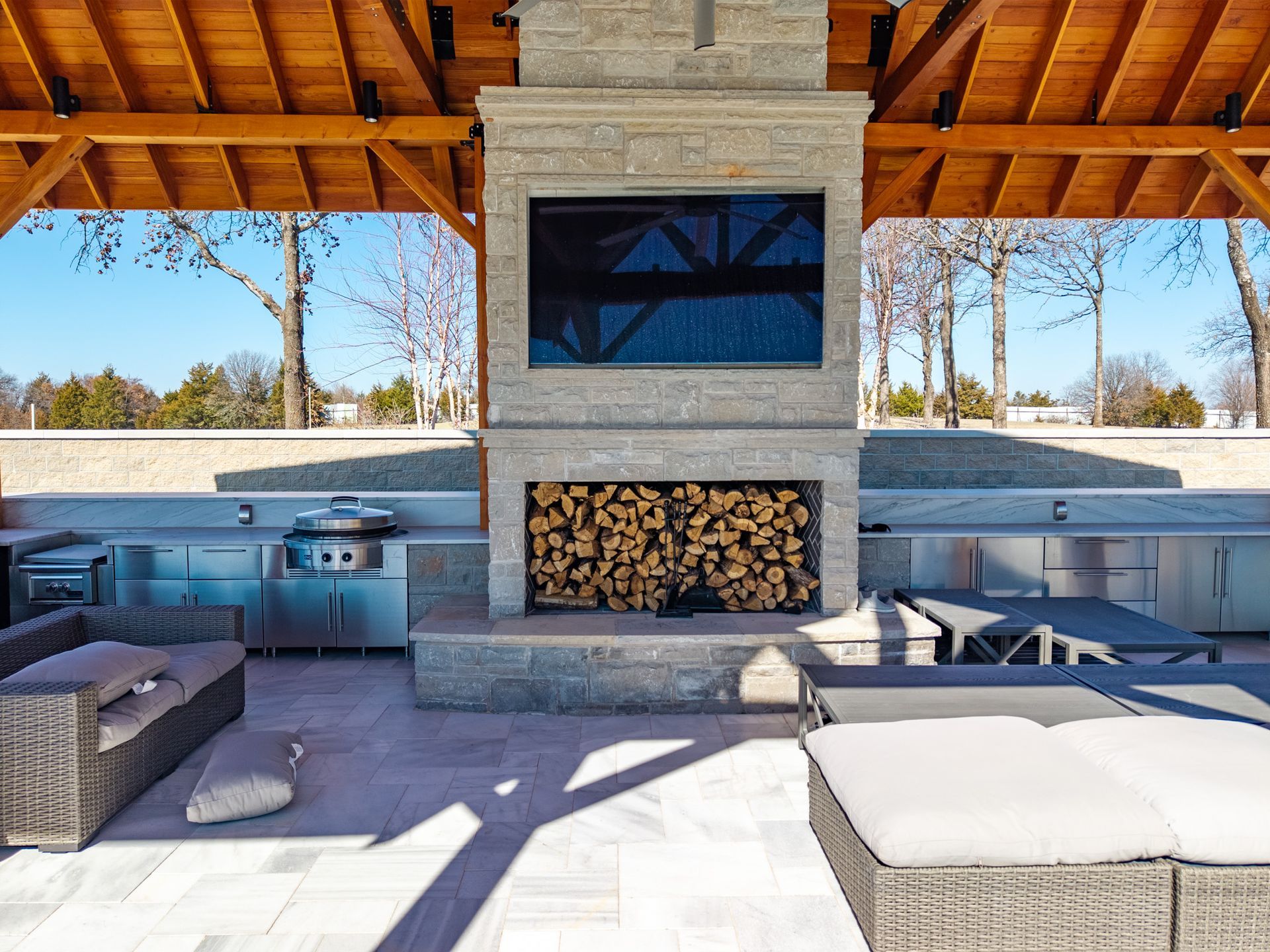 Expansive farmland bordered by trees under a partly cloudy sky.