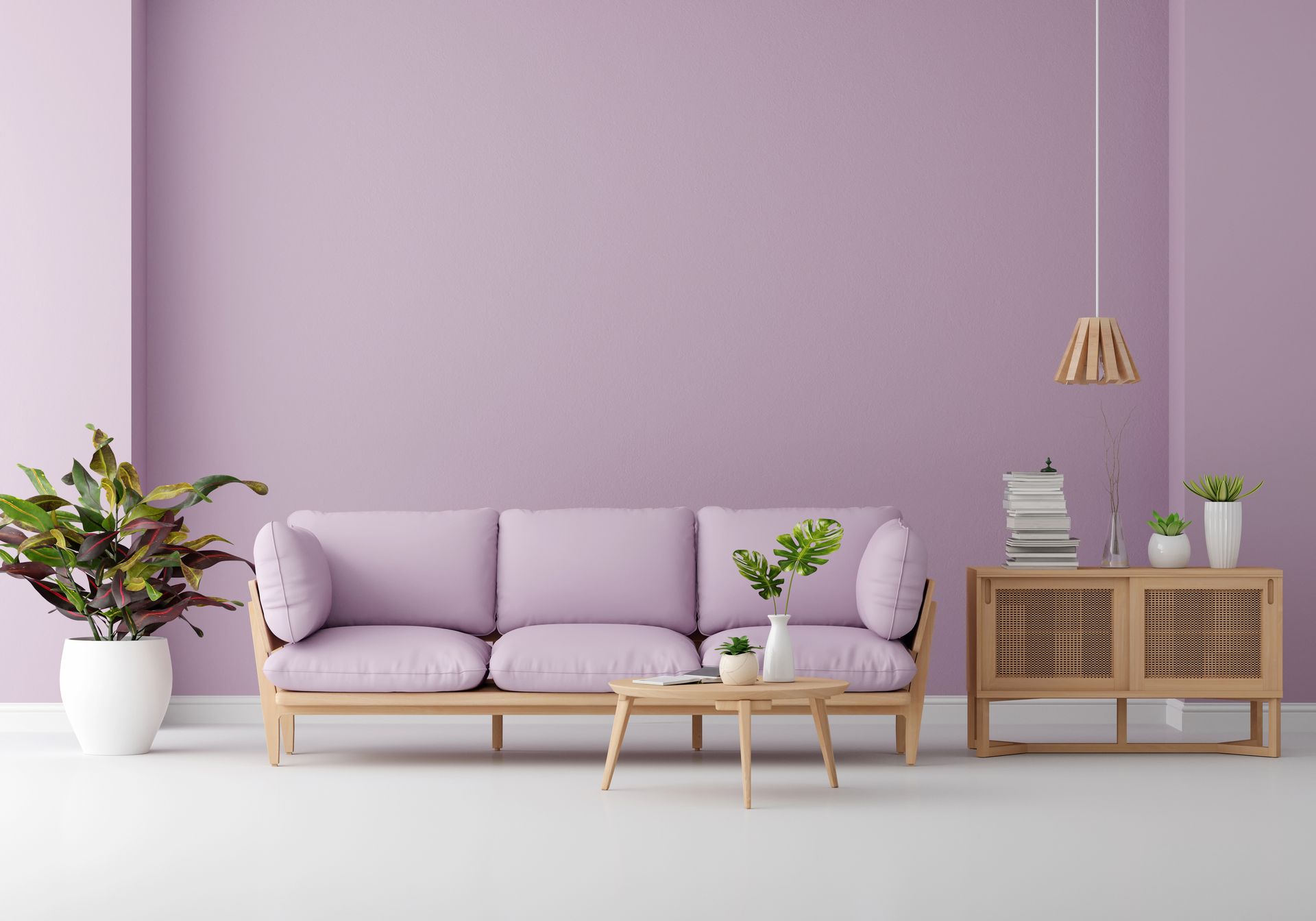 A living room with purple walls and a purple couch.