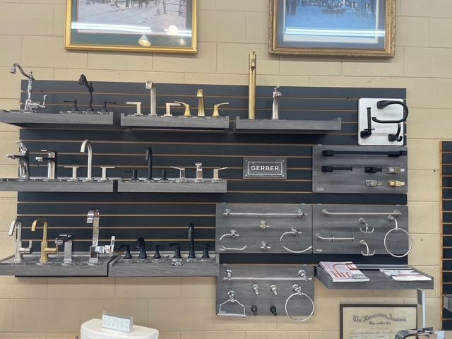 A wall with a lot of faucets and handles on it