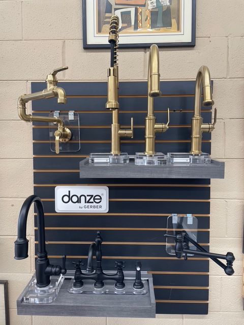 A display of brass and black faucets by danze