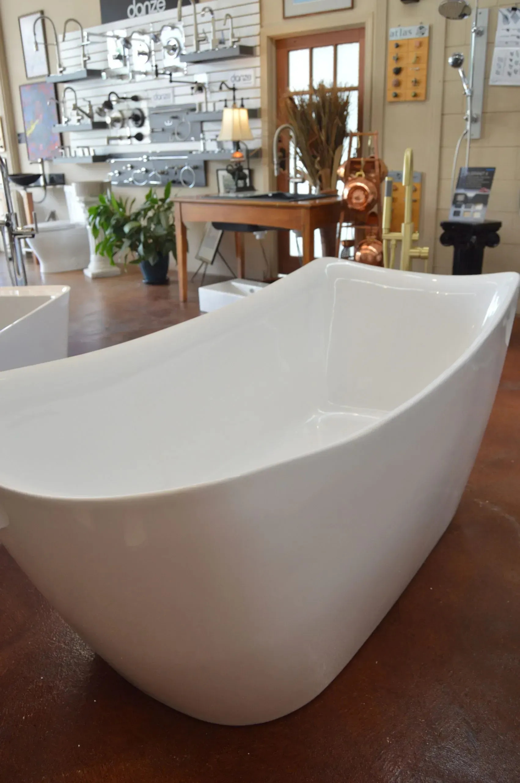 A white bathtub is sitting on a table in a bathroom