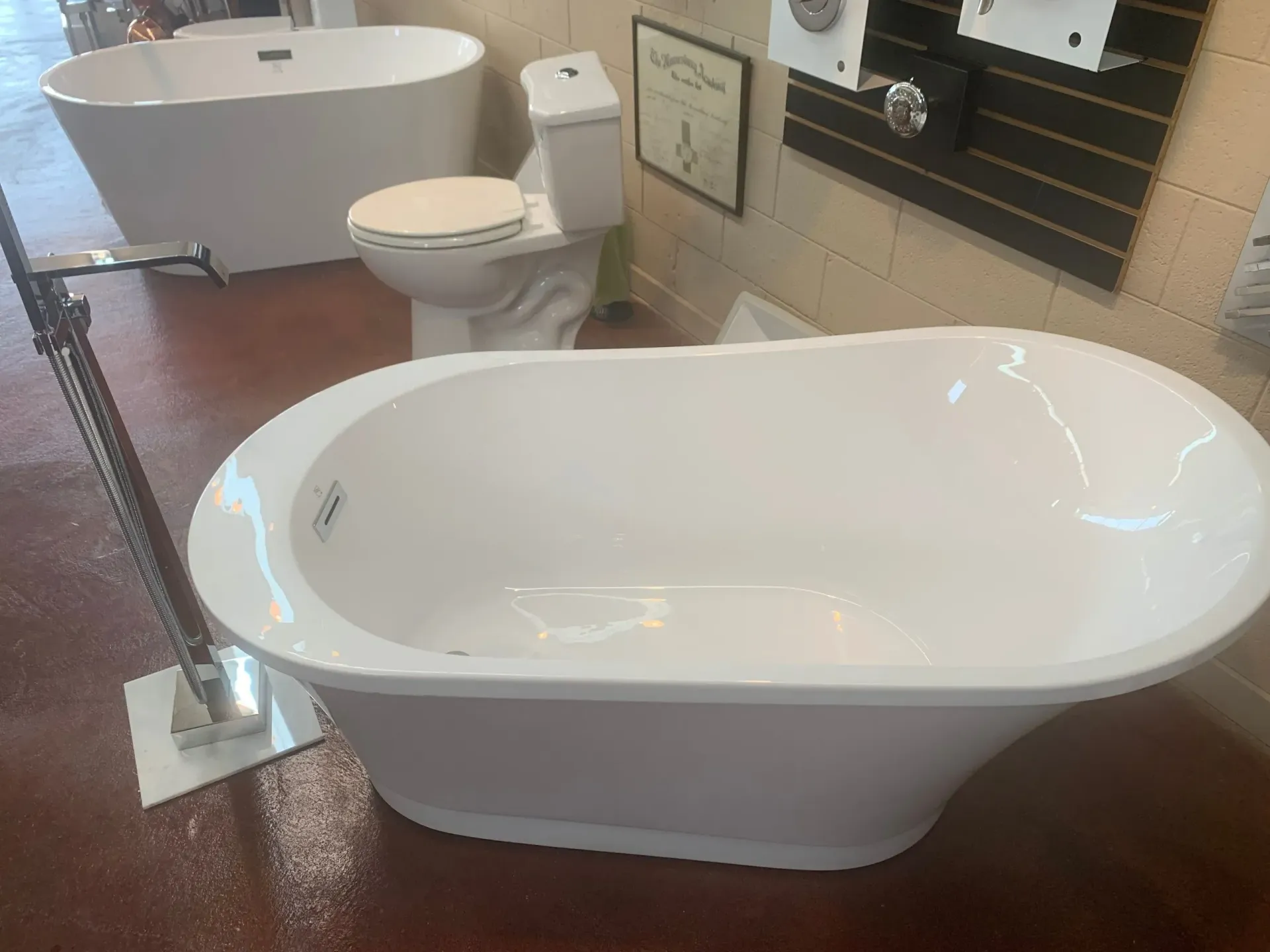 A white bathtub is sitting next to a toilet.