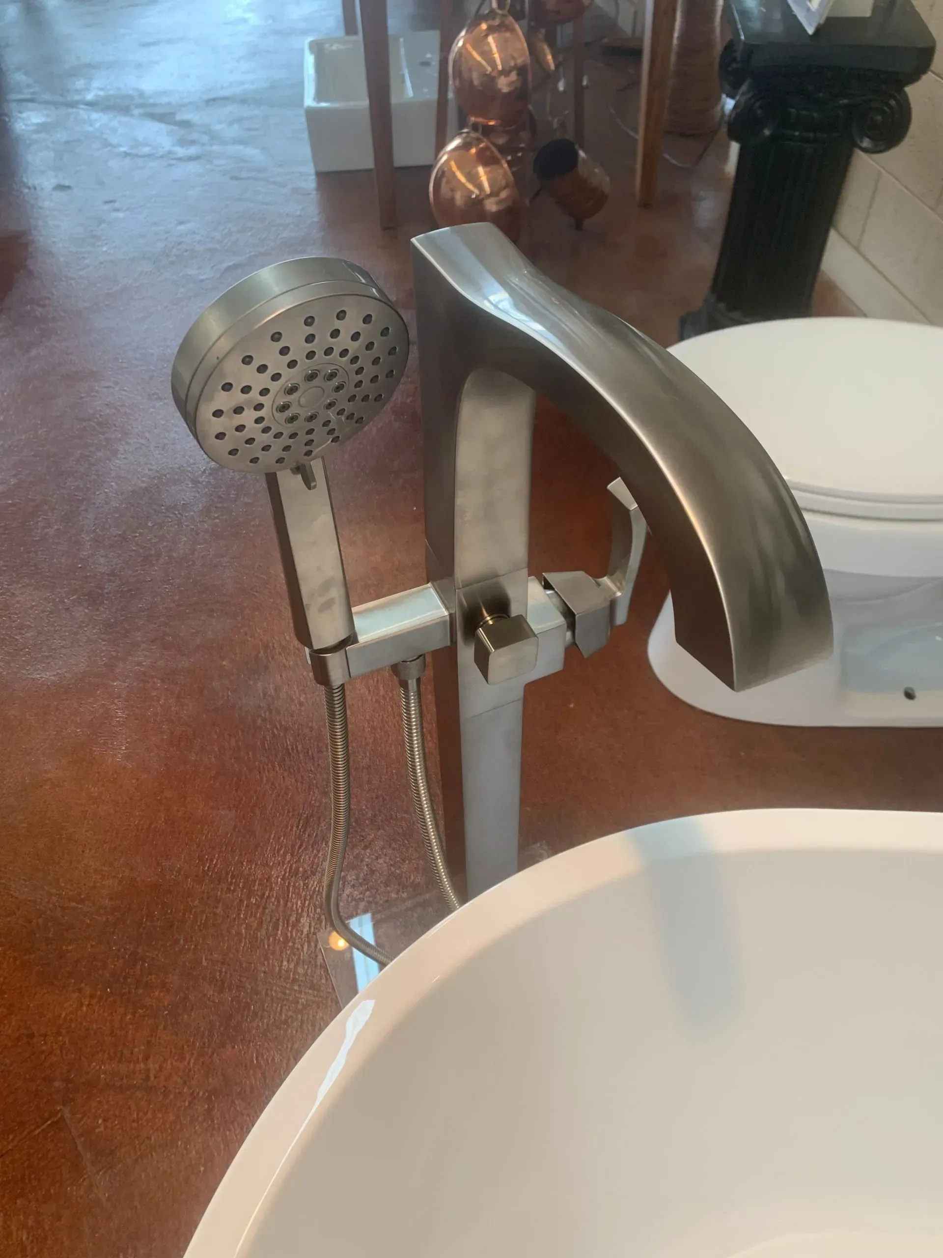A bathtub with a shower head attached to it