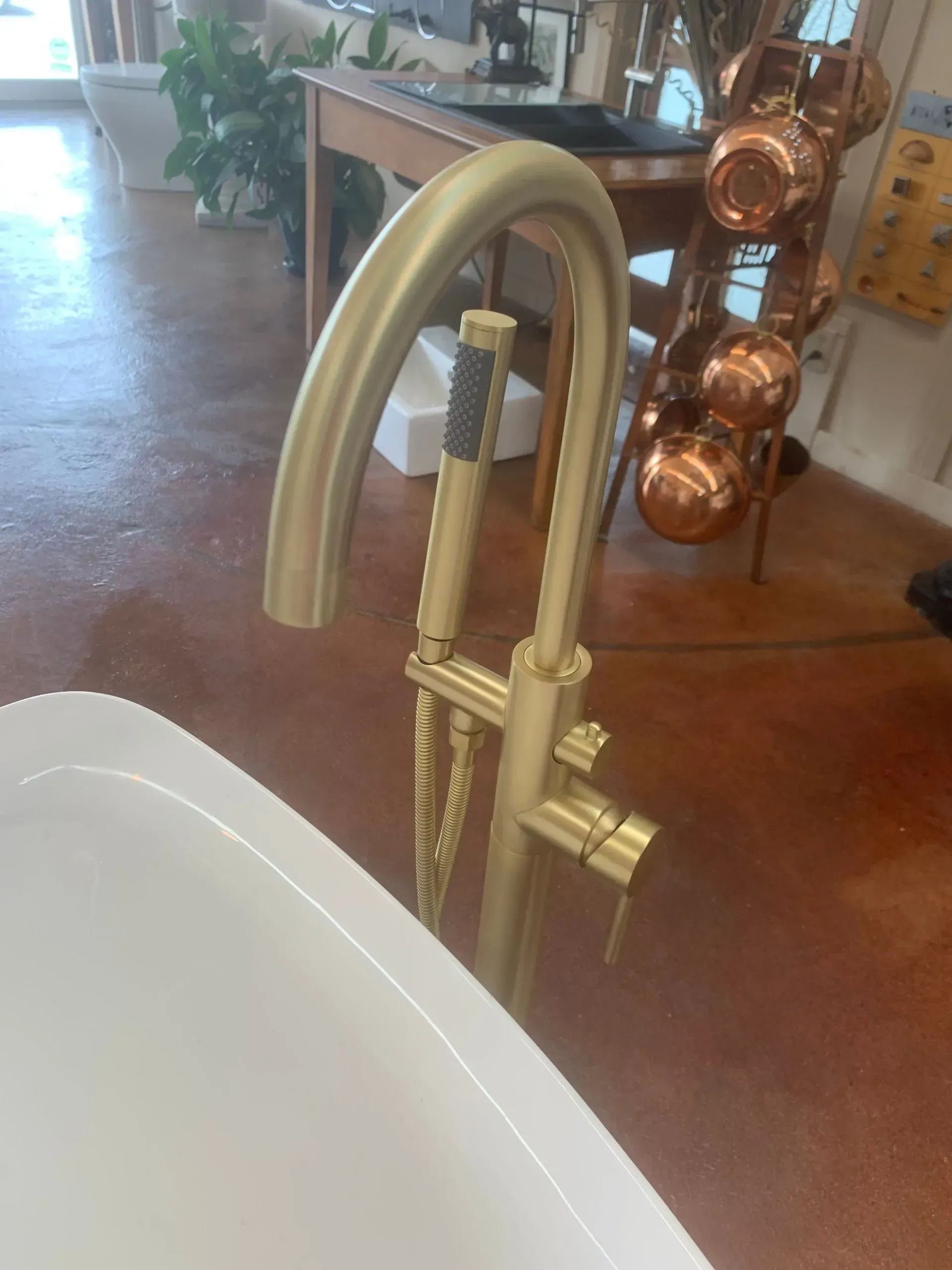 A bathtub with a brass faucet in a bathroom