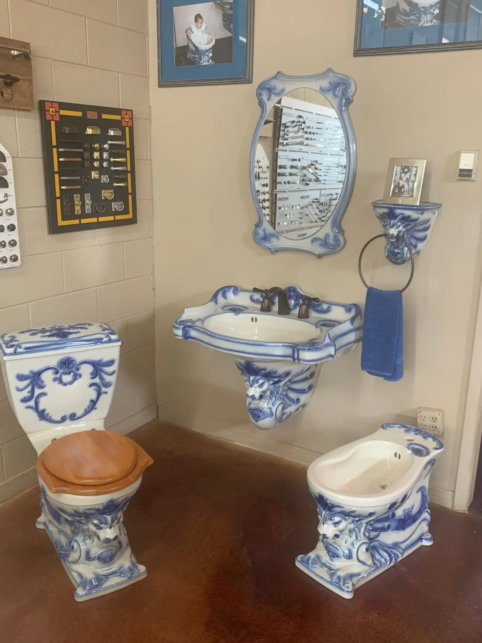 A blue and white bathroom with a toilet sink and bidet