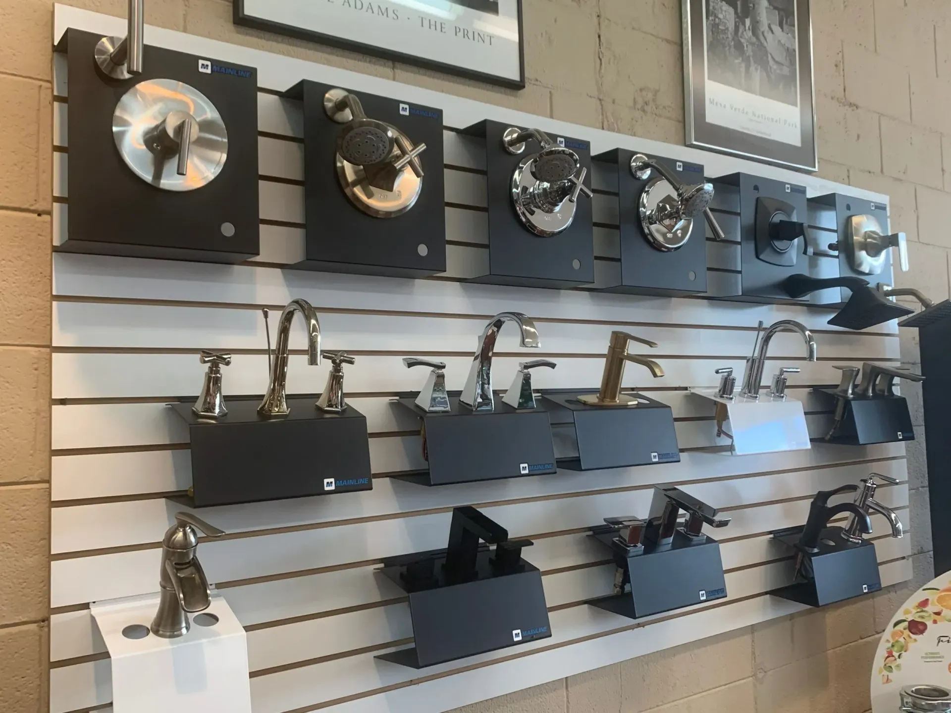 A wall with a bunch of faucets on it