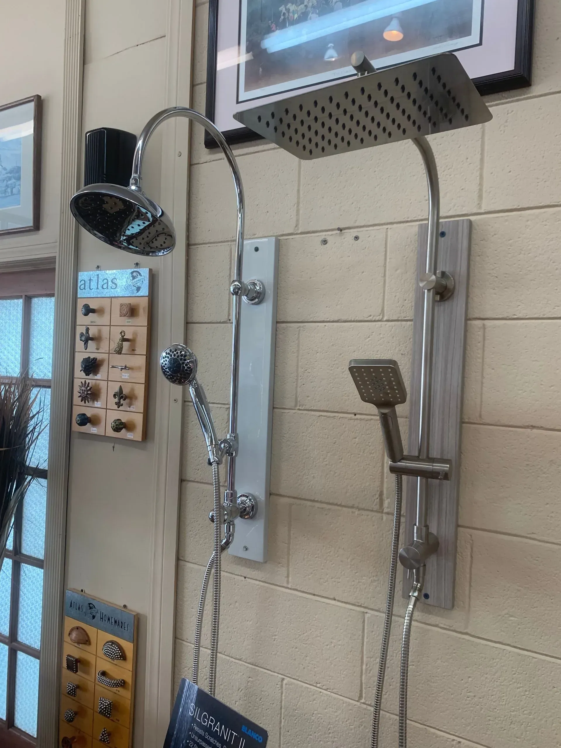 A shower head is hanging on a brick wall.