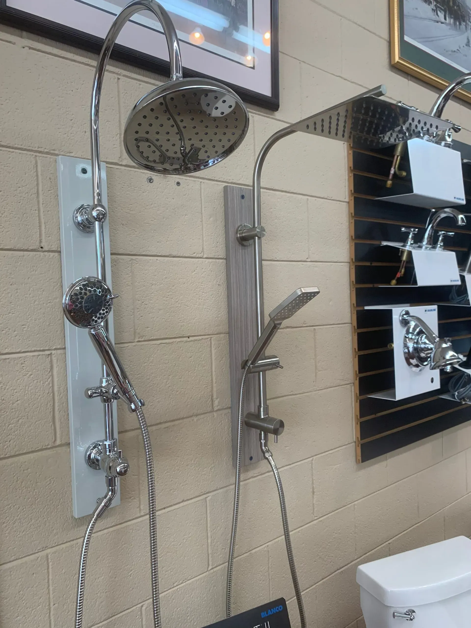 A shower head is hanging on a wall next to a toilet