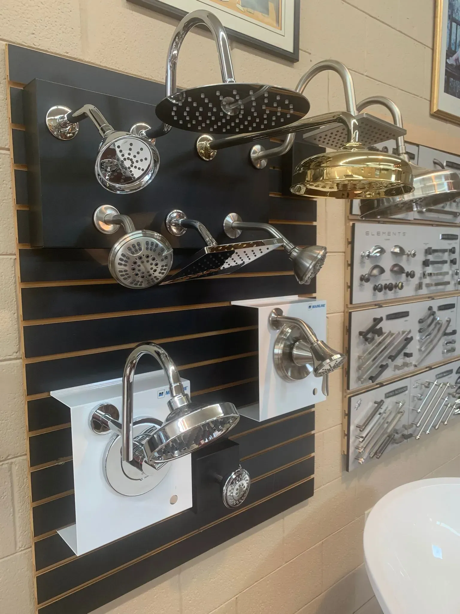 A display of shower heads and faucets in a bathroom.