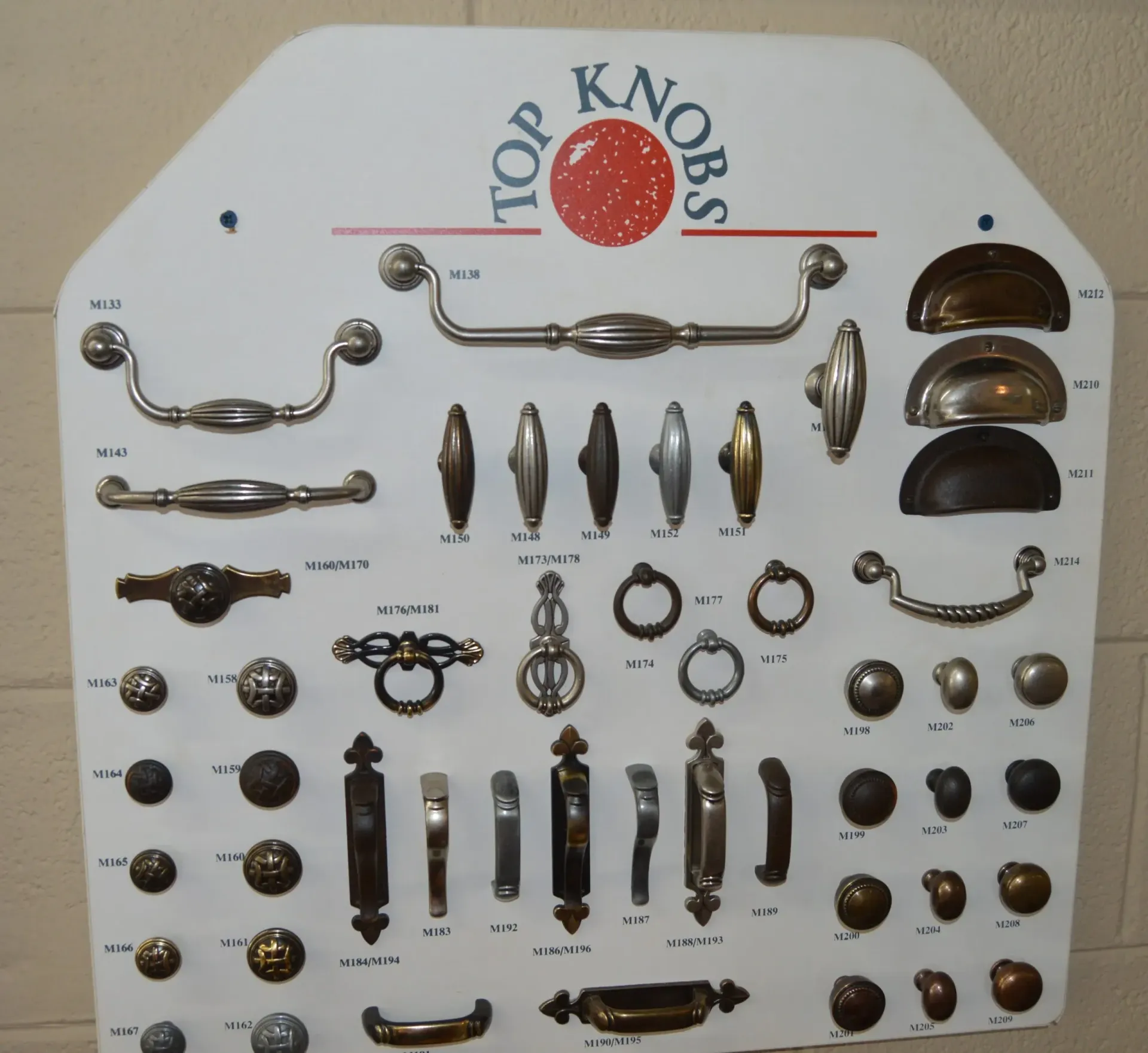 A white board with a red circle that says top knobs