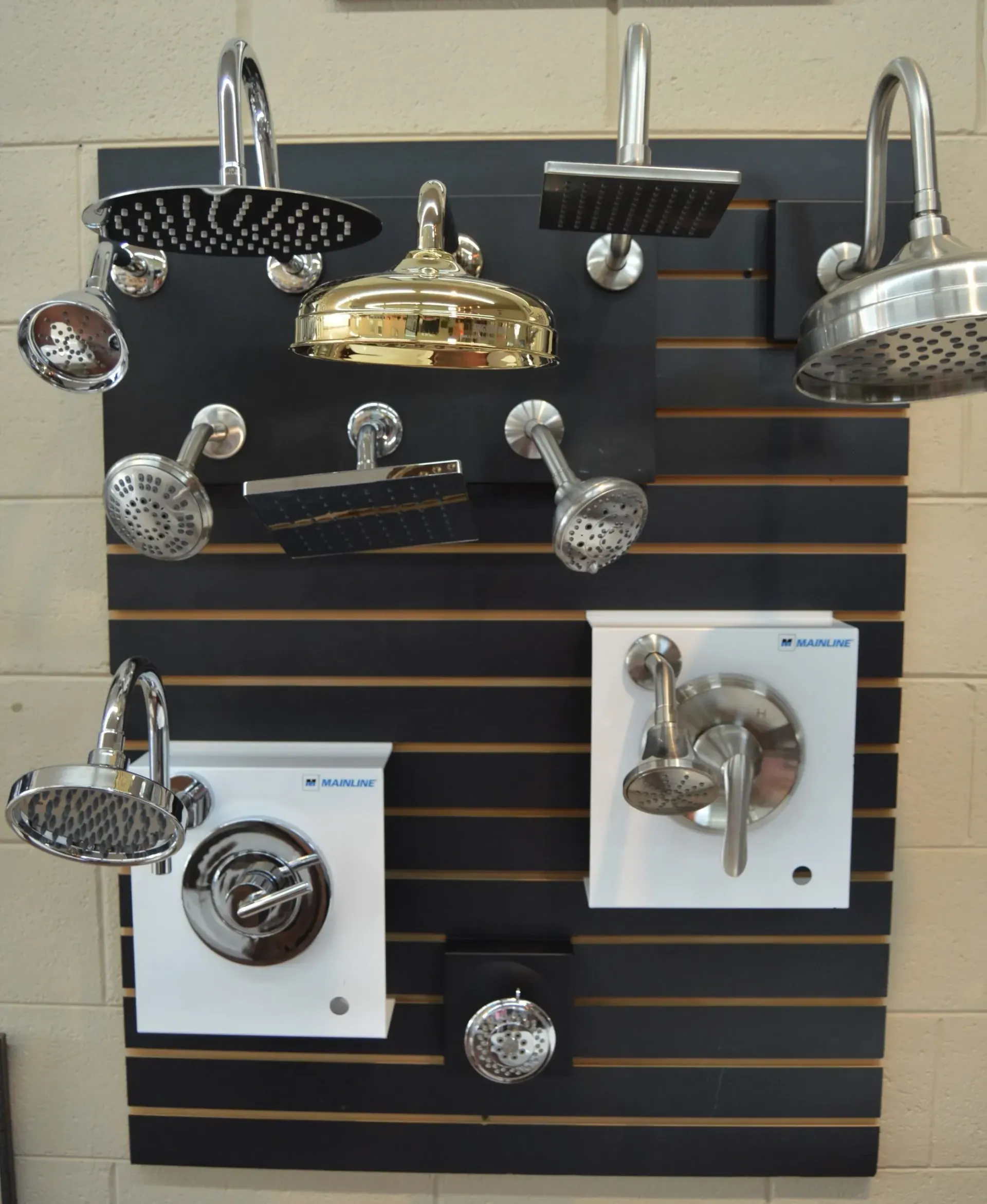 A display of shower heads and faucets on a wall