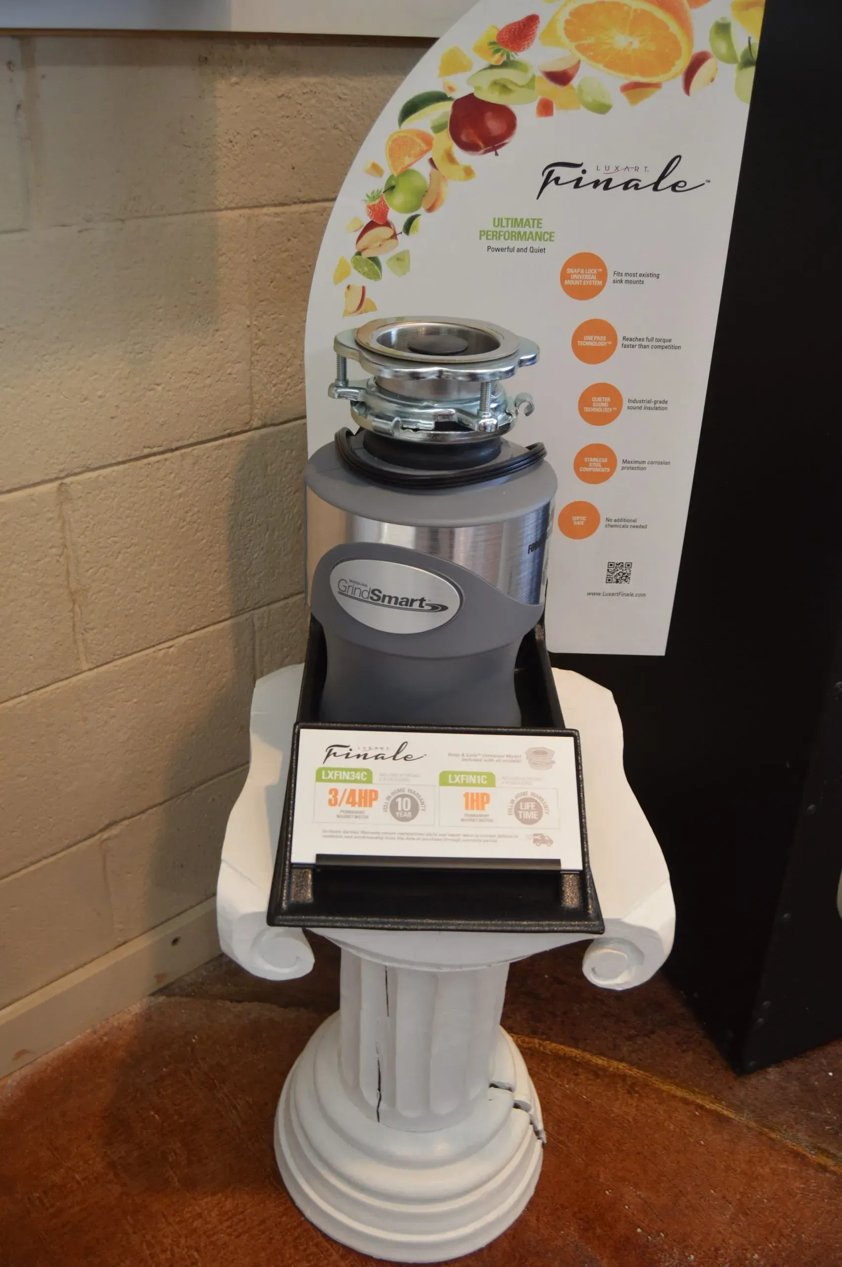 A garbage disposal is on display on a pedestal