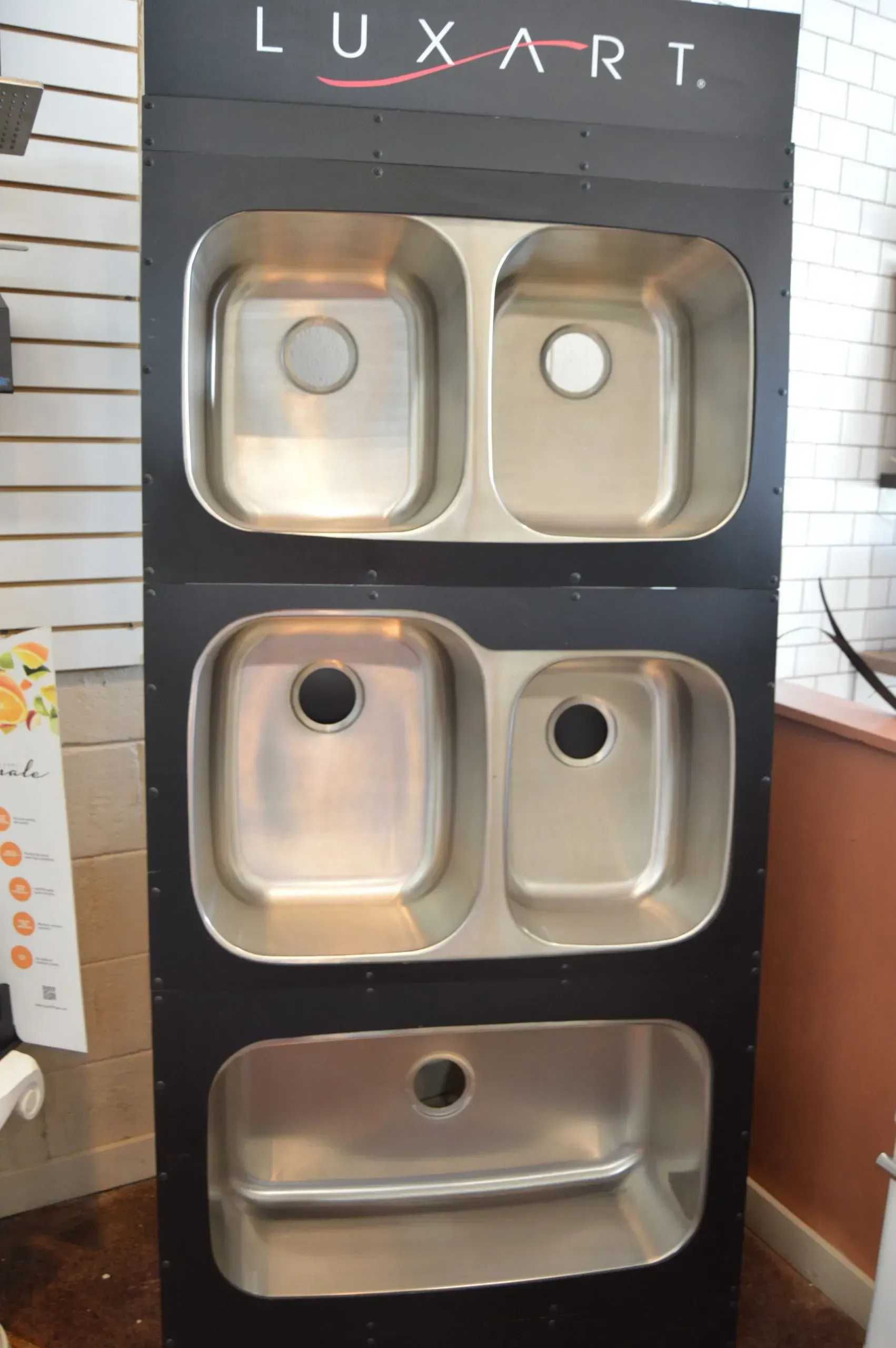 A display of luxart sinks stacked on top of each other