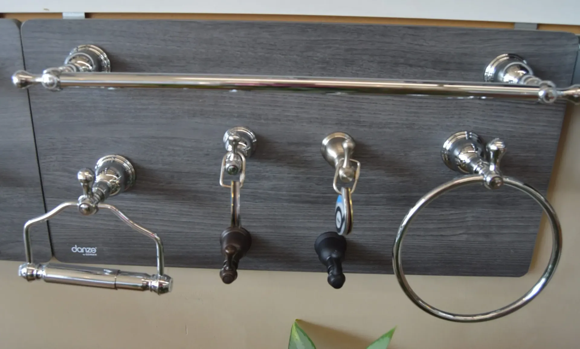 A towel rack with a toilet paper holder and a towel ring