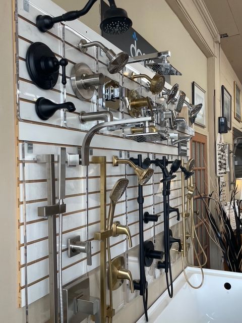 A wall with a bunch of shower heads on it