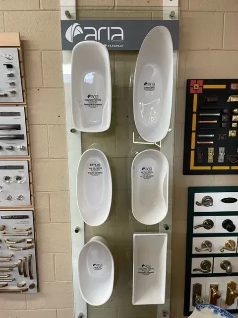 A display of white bowls and a sign that says aria