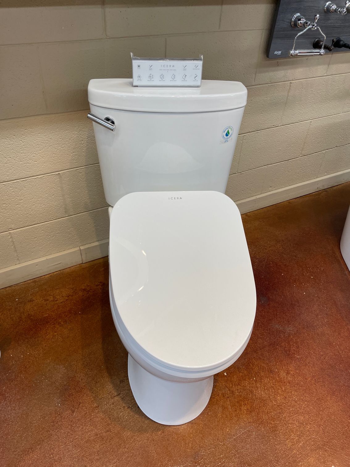 A white toilet is sitting on a concrete floor.