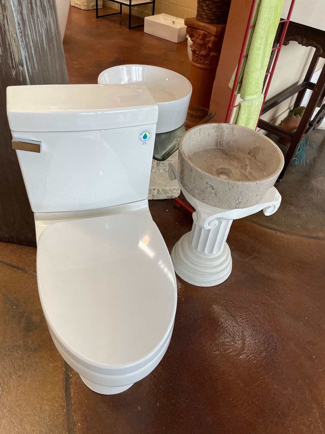 There is a toilet and a sink in the bathroom showroom.