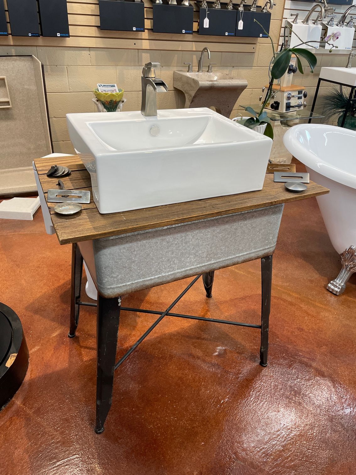 A sink is sitting on top of a wooden table. 