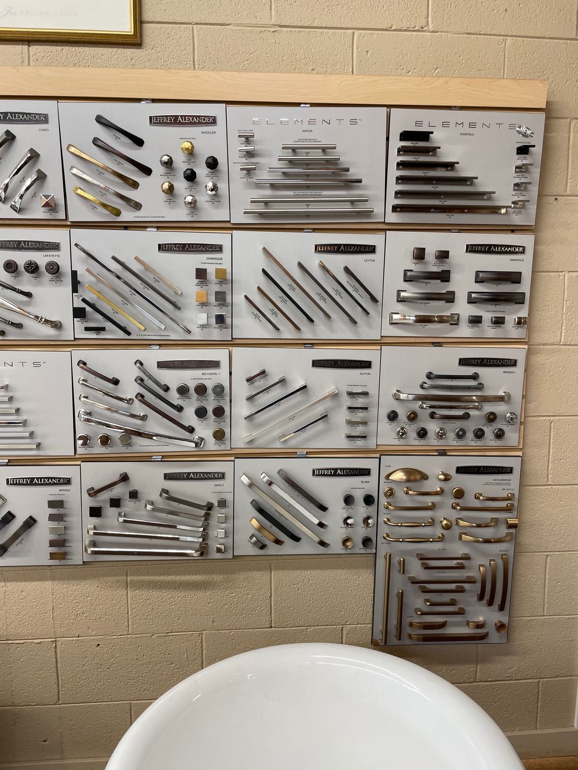 A display of different types of handles on a wall