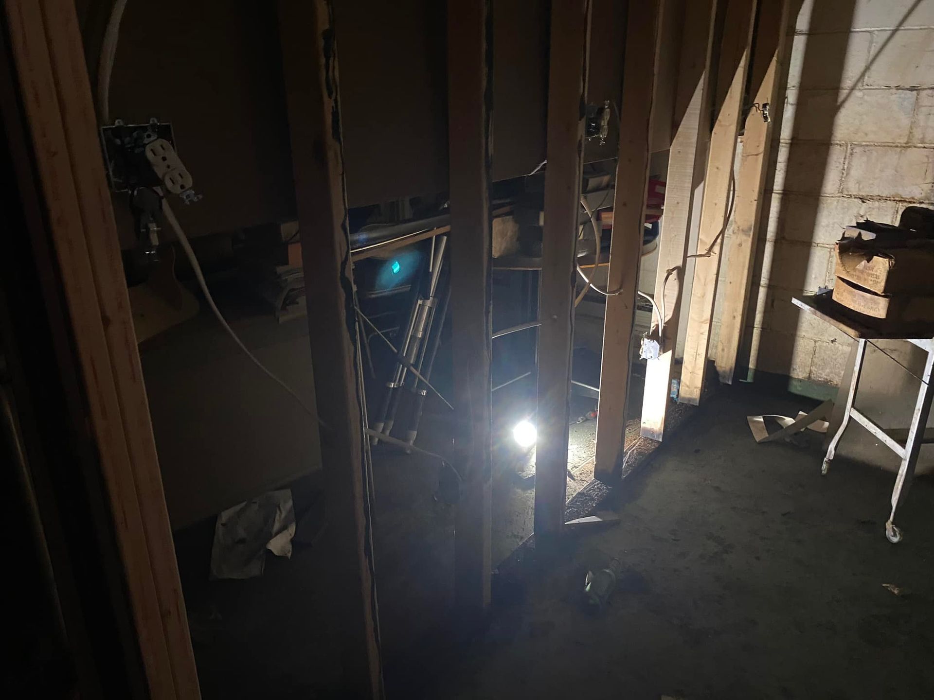 A dark room with a light shining through the walls.