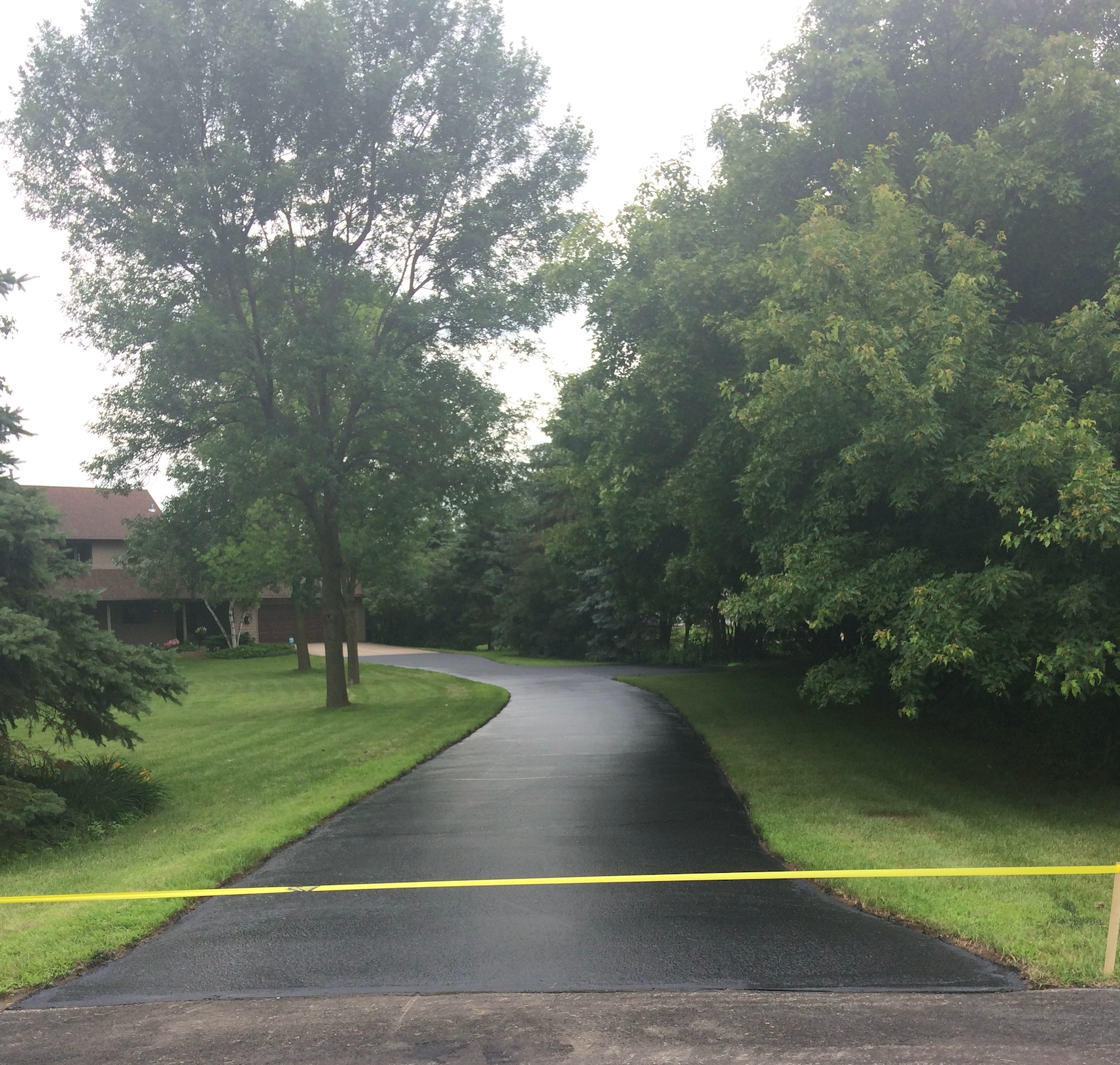 A road with a yellow tape along the side of it
