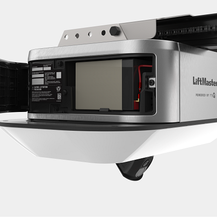 A silver LiftMaster garage door opener with a battery compartment open.