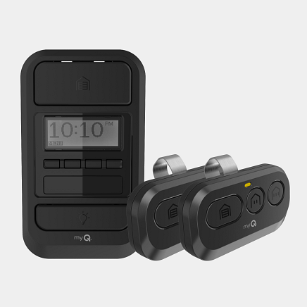 Black garage door opener set with wall control and two remotes.