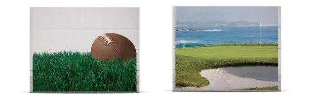 An American football on green grass and a golf course with the ocean in the background.