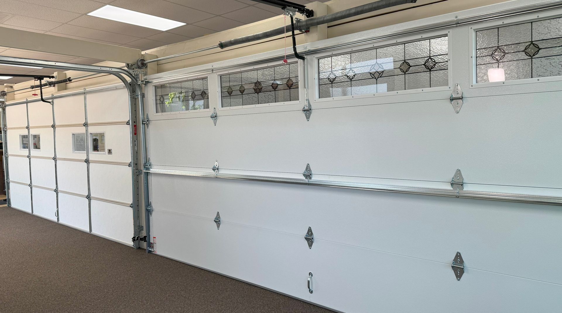 White garage door with glass panels open, revealing interior.