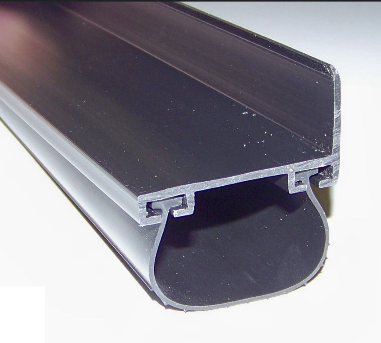 Black rubber garage door seal profile.
