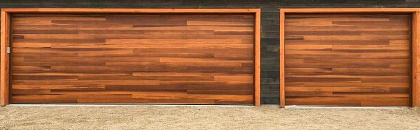 Two wooden garage doors with brown horizontal planks. The doors are framed with wood and are side by side.