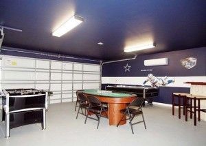 Game room in garage with blue ceiling, foosball, poker table, and Dallas Cowboys decor.