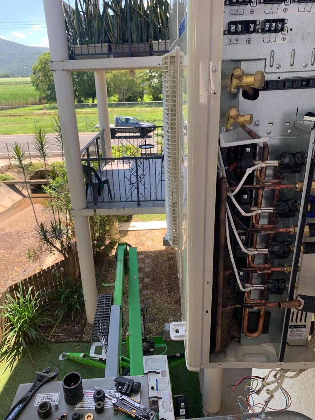 Air Conditioner Unit Open for Repair on Balcony — Don Hall Air Conditioning & Electrical in Smithfield, QLD