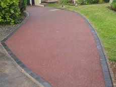 a brown colour driveway joining the entrance of the property