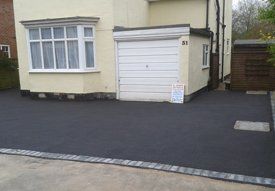 a driveway joining the entrance of the property and garage