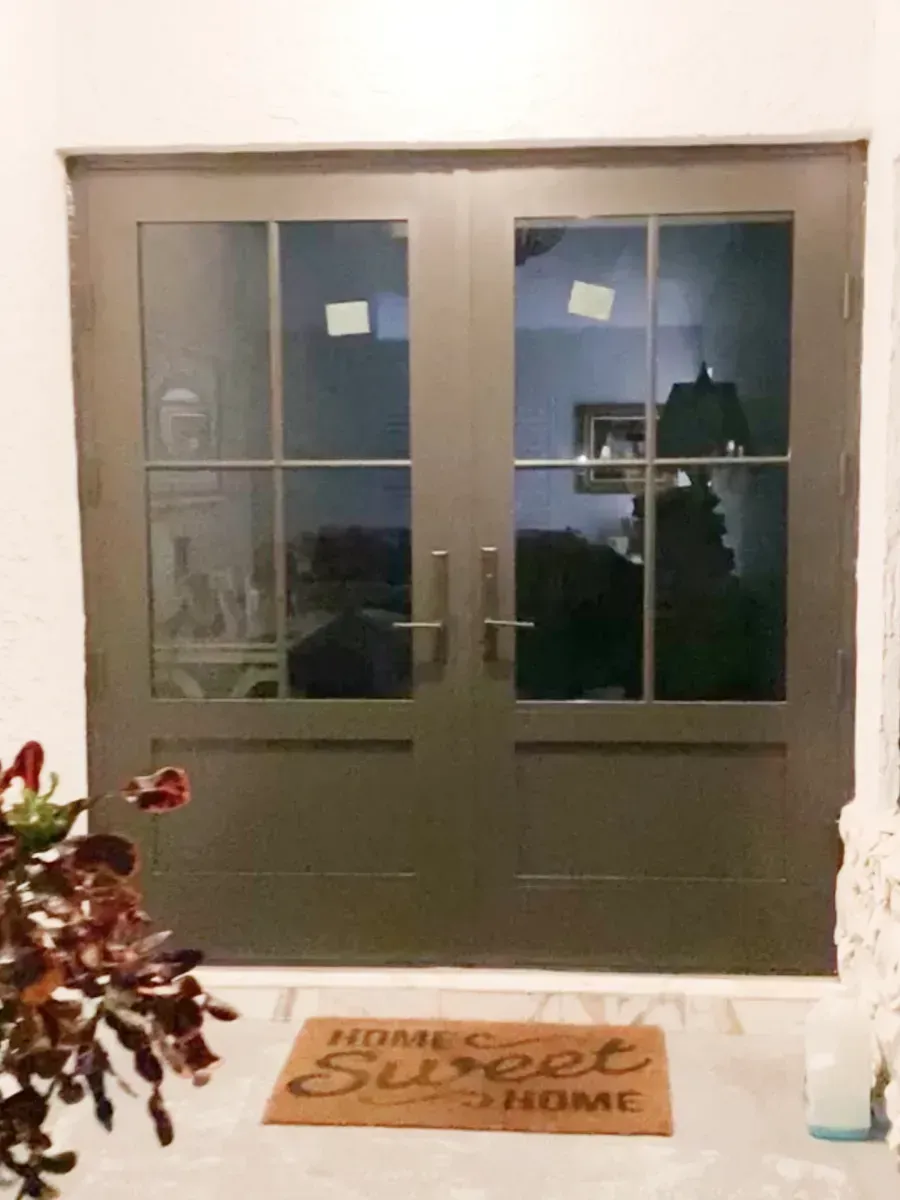 A dark-framed double glass door with a 